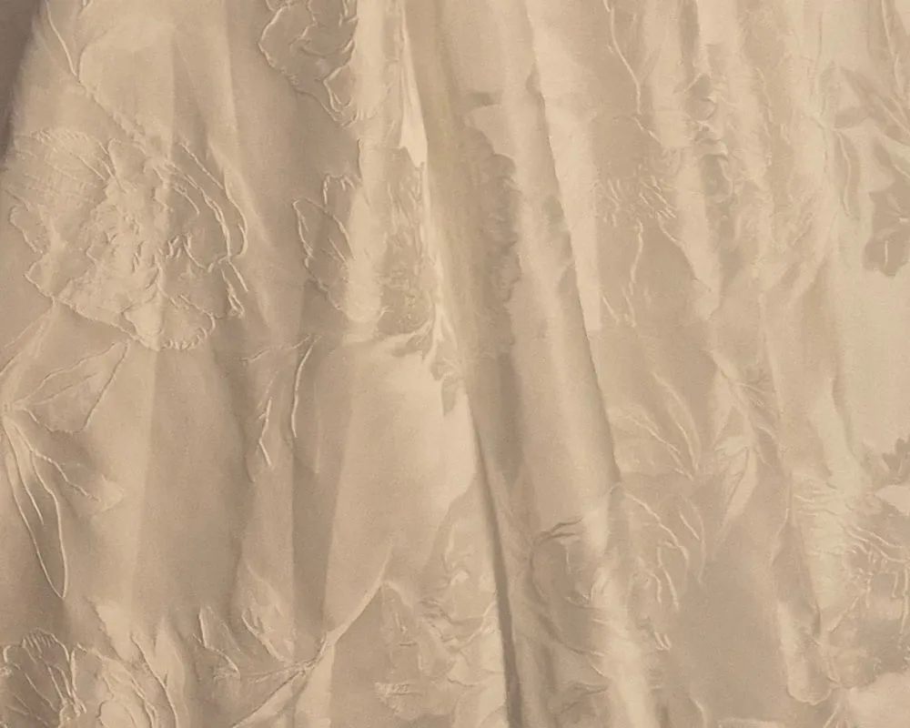 Close-up of a white jacquard skirt with a raised floral pattern